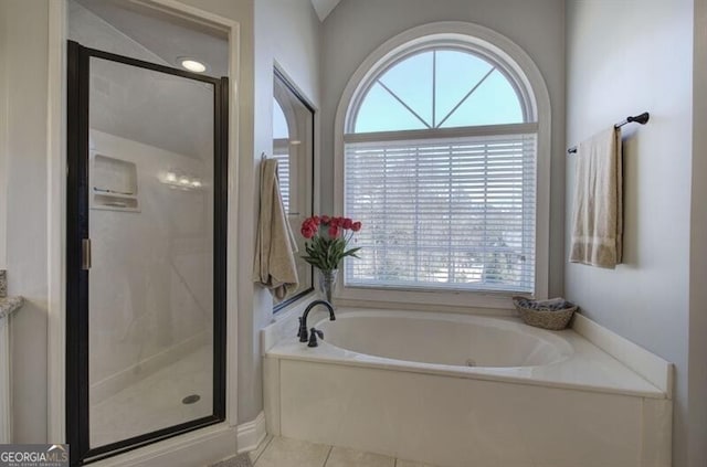 5327 Saville Dr NW, Acworth, GA 30101 - bathroom featuring healthy amount of natural light, a garden tub, a shower stall, and tile patterned floors