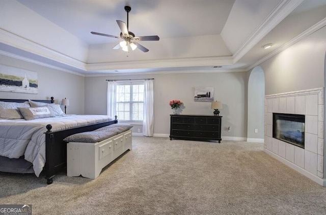 5327 Saville Dr NW, Acworth, GA 30101 - bedroom with a raised ceiling, ornamental molding, a tile fireplace, carpet floors, and a ceiling fan