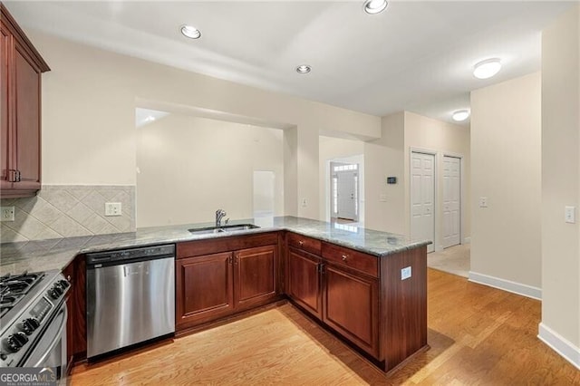 2001 Macland Square Dr Unit 11, Marietta, GA 30064 - kitchen featuring stainless steel appliances, a sink, light wood finished floors, a peninsula, and stone counters