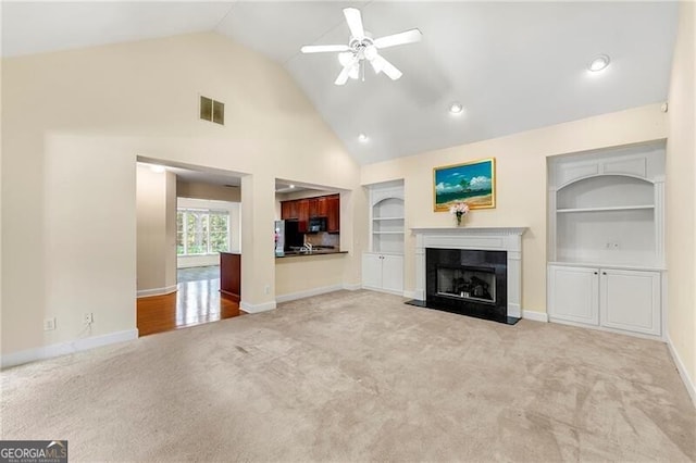 2001 Macland Square Dr Unit 11, Marietta, GA 30064 - unfurnished living room featuring light colored carpet, ceiling fan, built in shelves, a premium fireplace, and baseboards