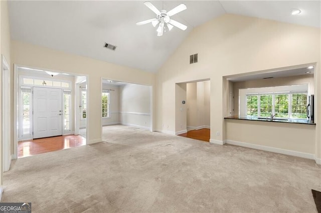 2001 Macland Square Dr Unit 11, Marietta, GA 30064 - unfurnished living room with high vaulted ceiling, carpet flooring, ceiling fan, baseboards, and a sink
