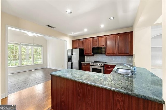 2001 Macland Square Dr Unit 11, Marietta, GA 30064 - kitchen featuring stainless steel appliances, a sink, tasteful backsplash, stone countertops, and a peninsula