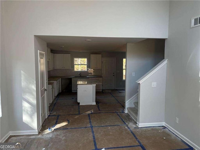 192 Paces Lakes Pt, Dallas, GA 30157 - kitchen featuring a center island, a sink, white cabinets, and baseboards