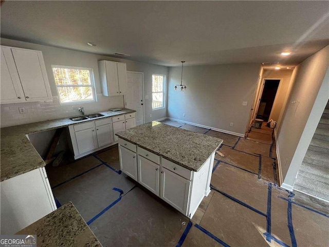 192 Paces Lakes Pt, Dallas, GA 30157 - kitchen featuring baseboards, a sink, white cabinetry, and light stone countertops