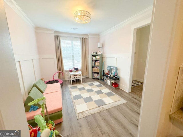 2991 Rice Creek Ct Unit 84P, Jefferson, GA 30549 - playroom with crown molding, wainscoting, wood finished floors, and a decorative wall