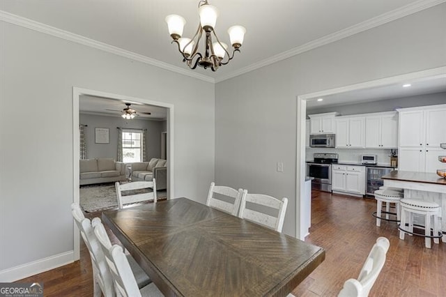 440 S Alexander St, Buford, GA 30518 - dining area with crown molding, a chandelier, dark wood-style floors, and baseboards