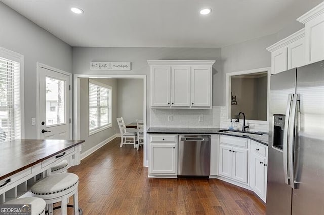 440 S Alexander St, Buford, GA 30518 - kitchen with appliances with stainless steel finishes, a sink, white cabinetry, dark wood-style flooring, and dark countertops