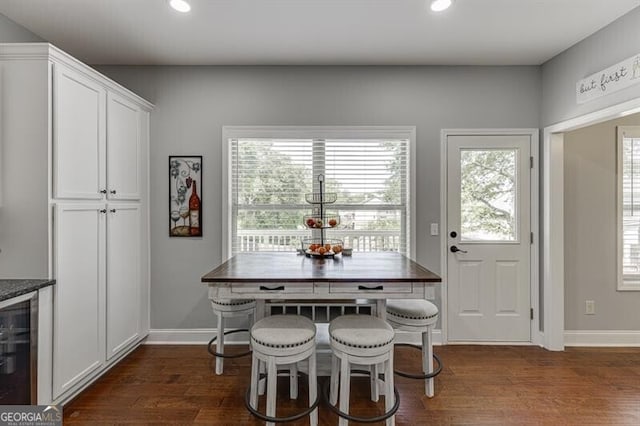 440 S Alexander St, Buford, GA 30518 - dining space with dark wood-type flooring, recessed lighting, beverage cooler, and baseboards