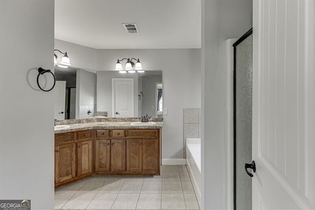 440 S Alexander St, Buford, GA 30518 - full bath featuring tile patterned floors, a garden tub, double vanity, a stall shower, and baseboards