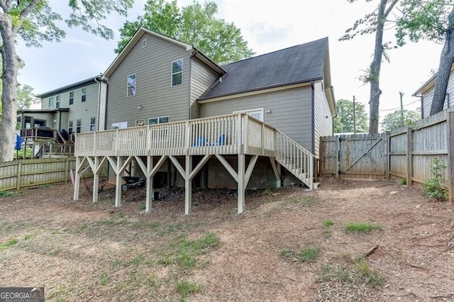 440 S Alexander St, Buford, GA 30518 - rear view of house with a deck, a fenced backyard, a gate, and roof with shingles