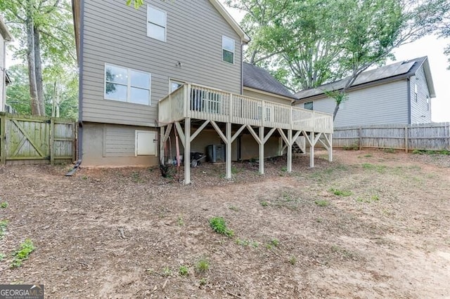 440 S Alexander St, Buford, GA 30518 - rear view of house featuring a wooden deck, a fenced backyard, central air condition unit, and a gate