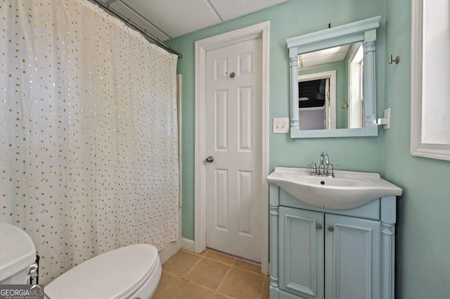 6645 N Glen Dr, Cumming, GA 30028 - full bath featuring toilet, vanity, tile patterned floors, and a shower with curtain