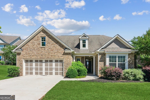 4416 Links Blvd, Jefferson, GA 30549 - view of front of home with brick siding, concrete driveway, a front yard, a garage, and a shingled roof