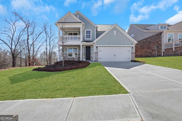6775 Cambridge Dr, Flowery Branch, GA 30542 - view of front of property with a balcony, driveway, a front yard, a garage, and stone siding