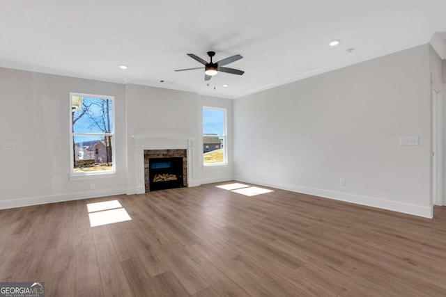 6775 Cambridge Dr, Flowery Branch, GA 30542 - unfurnished living room featuring a fireplace, ceiling fan, wood finished floors, and recessed lighting