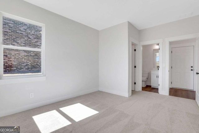 6775 Cambridge Dr, Flowery Branch, GA 30542 - unfurnished bedroom featuring carpet flooring, baseboards, and connected bathroom