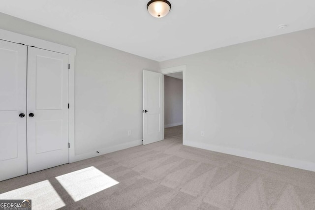 6775 Cambridge Dr, Flowery Branch, GA 30542 - unfurnished bedroom with carpet floors, baseboards, and a closet