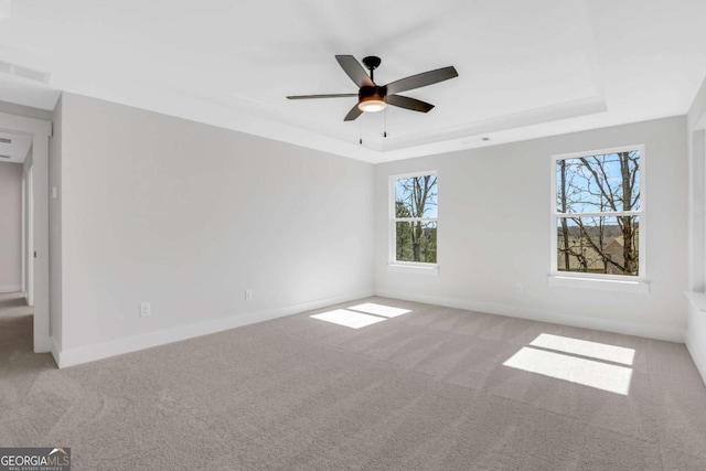 6775 Cambridge Dr, Flowery Branch, GA 30542 - spare room with carpet floors, a tray ceiling, healthy amount of natural light, and a ceiling fan