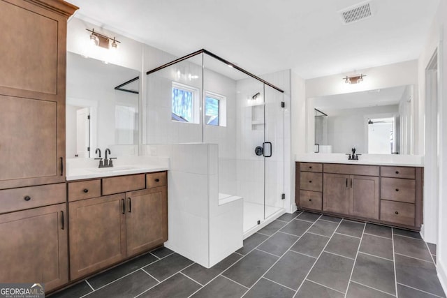 6775 Cambridge Dr, Flowery Branch, GA 30542 - full bathroom with a shower stall, tile patterned floors, and two vanities