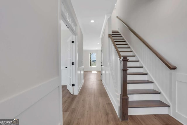 6775 Cambridge Dr, Flowery Branch, GA 30542 - stairs featuring wood finished floors, recessed lighting, and baseboards