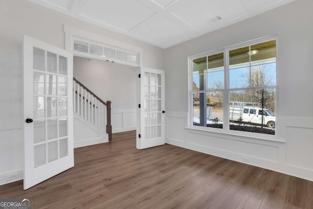 6775 Cambridge Dr, Flowery Branch, GA 30542 - spare room featuring french doors, wood finished floors, coffered ceiling, stairway, and a wainscoted wall