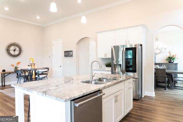 2665 Crowbrook Way, Cumming, GA 30040 - kitchen featuring stainless steel appliances, arched walkways, dark wood finished floors, white cabinets, and ornamental molding