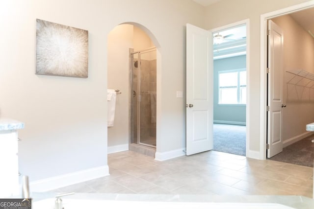 2665 Crowbrook Way, Cumming, GA 30040 - corridor featuring arched walkways, light tile patterned floors, and light colored carpet