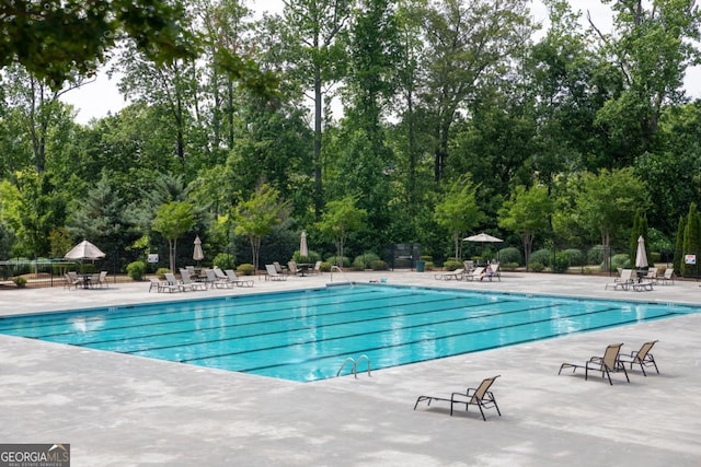 2665 Crowbrook Way, Cumming, GA 30040 - community pool with a patio area and view of wooded area