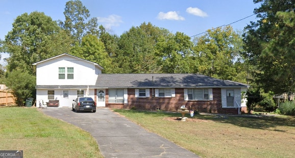624 Newtown Creek Loop NE, Calhoun, GA 30701 - view of front of home featuring asphalt driveway, a front yard, brick siding, and a garage