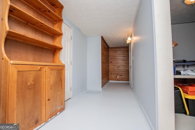 258 Big Oak Rd, Whitesburg, GA 30185 - hall with a textured ceiling, wooden walls, baseboards, and finished concrete flooring