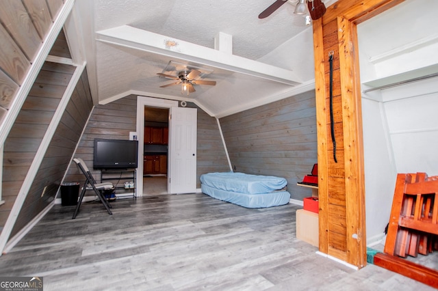 258 Big Oak Rd, Whitesburg, GA 30185 - additional living space with ceiling fan, wooden walls, lofted ceiling, wood finished floors, and a textured ceiling