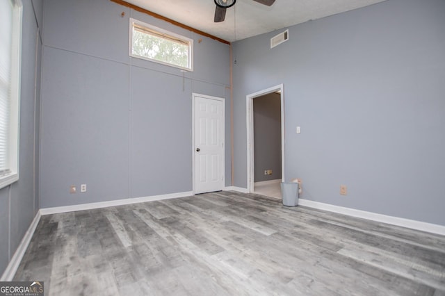 258 Big Oak Rd, Whitesburg, GA 30185 - empty room featuring a ceiling fan, wood finished floors, baseboards, and a towering ceiling
