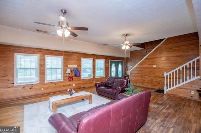 258 Big Oak Rd, Whitesburg, GA 30185 - living area with wood walls, a ceiling fan, wood finished floors, and stairway