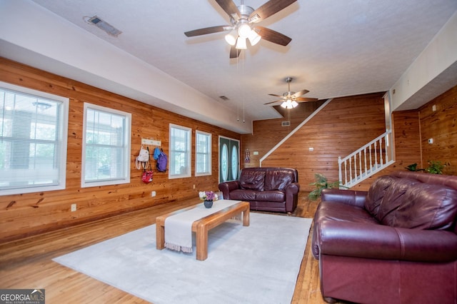 258 Big Oak Rd, Whitesburg, GA 30185 - living area with wood walls, ceiling fan, wood finished floors, and stairway