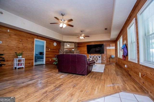 258 Big Oak Rd, Whitesburg, GA 30185 - living room featuring wood walls, ceiling fan, and hardwood / wood-style floors