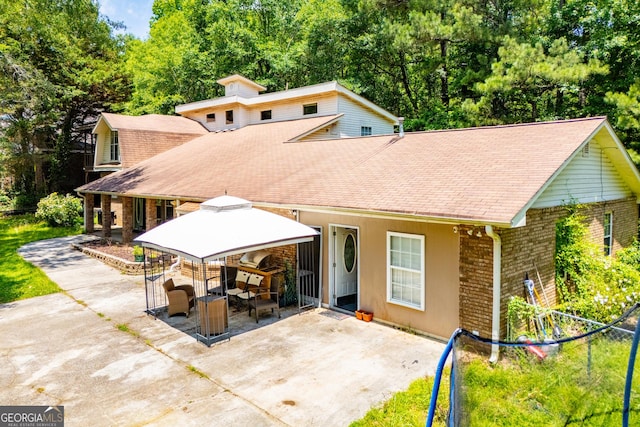258 Big Oak Rd, Whitesburg, GA 30185 - back of property featuring a patio, roof with shingles, brick siding, and a gazebo