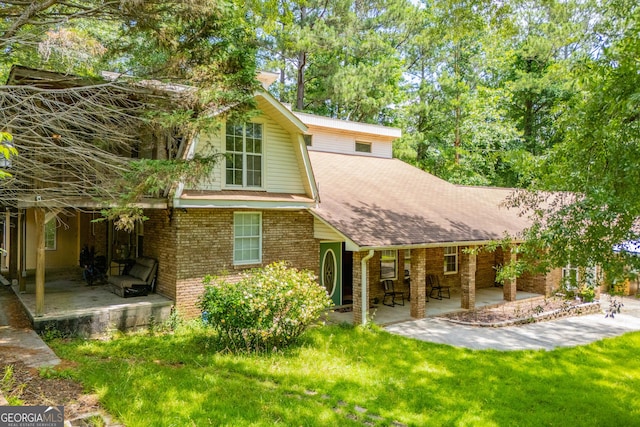 258 Big Oak Rd, Whitesburg, GA 30185 - back of house with a porch, brick siding, a yard, and a shingled roof
