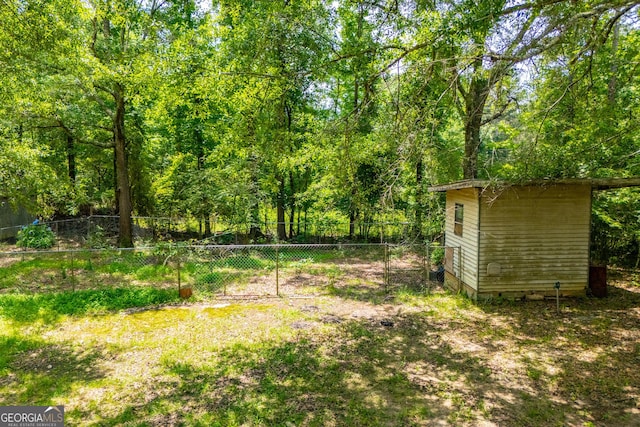 258 Big Oak Rd, Whitesburg, GA 30185 - view of yard with an outbuilding and a view of trees