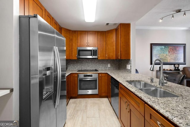 1101 Juniper St NE Unit 1216, Atlanta, GA 30309 - kitchen with black appliances, a sink, brown cabinetry, light stone countertops, and crown molding