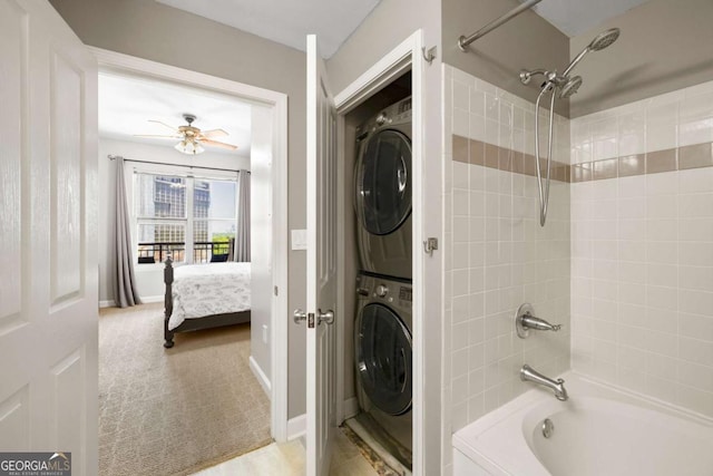 1101 Juniper St NE Unit 1216, Atlanta, GA 30309 - bathroom featuring stacked washing machine and dryer, shower / bathtub combination, connected bathroom, ceiling fan, and baseboards