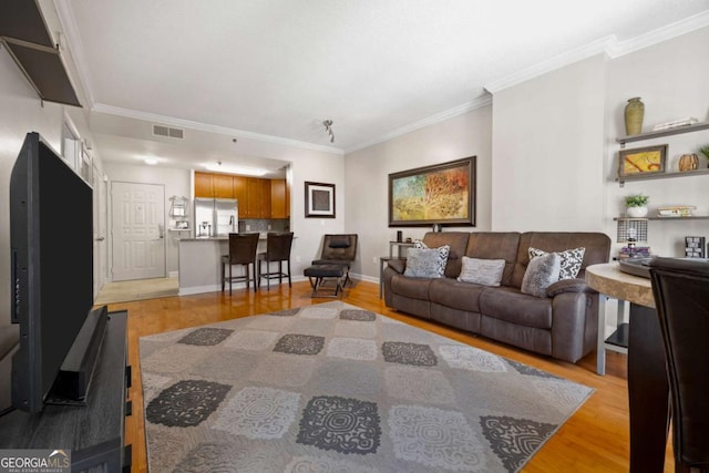 1101 Juniper St NE Unit 1216, Atlanta, GA 30309 - living room with light wood-style flooring, ornamental molding, and baseboards