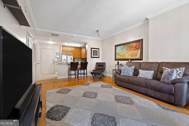 1101 Juniper St NE Unit 1216, Atlanta, GA 30309 - living room featuring light wood-style flooring, crown molding, and baseboards