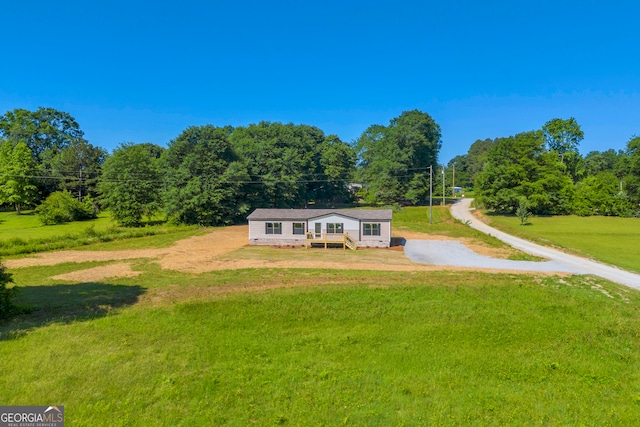 33 Marigold Dr, Carnesville, GA 30521 - view of front of home with a deck, a front lawn, dirt driveway, and a wooded view