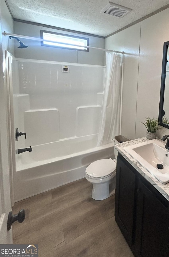 33 Marigold Dr, Carnesville, GA 30521 - full bathroom with a textured ceiling, shower / bath combo, vanity, wood finished floors, and toilet