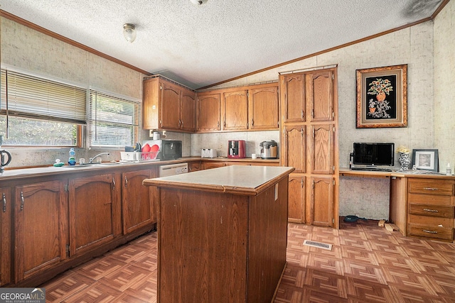 23 Wood Bine Ln, Crawford, GA 30630 - kitchen with vaulted ceiling, ornamental molding, brown cabinetry, a textured ceiling, and a center island