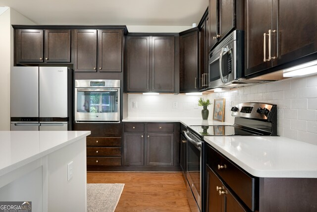 372 Abbington Way, Clarkesville, GA 30523 - kitchen featuring stainless steel appliances, dark brown cabinets, light countertops, and tasteful backsplash