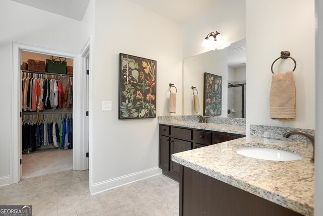 372 Abbington Way, Clarkesville, GA 30523 - full bath featuring a stall shower, vanity, tile patterned floors, baseboards, and a walk in closet