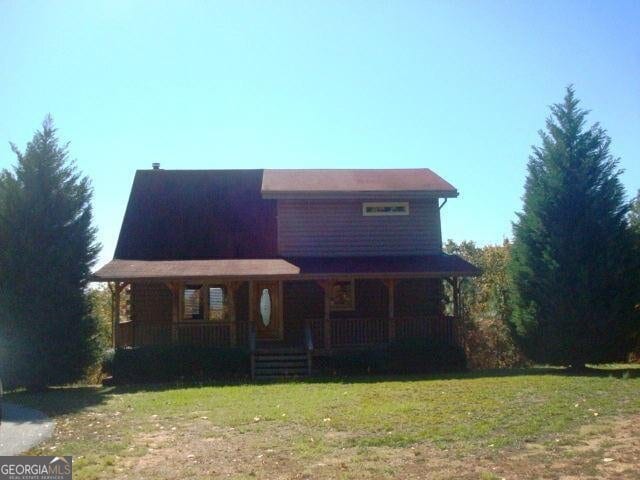 697 Waddell Rd, Woodbury, GA 30293 - log home featuring a porch and a front yard