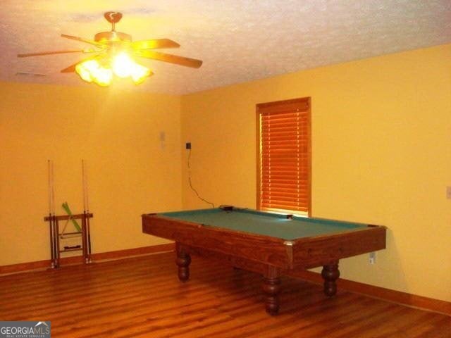 697 Waddell Rd, Woodbury, GA 30293 - rec room with wood finished floors, billiards table, baseboards, a ceiling fan, and a textured ceiling