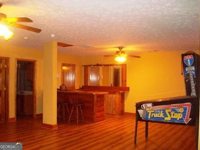 697 Waddell Rd, Woodbury, GA 30293 - game room with ceiling fan, wood finished floors, a textured ceiling, and baseboards